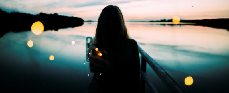 Silhouette of a girl sitting in a boat