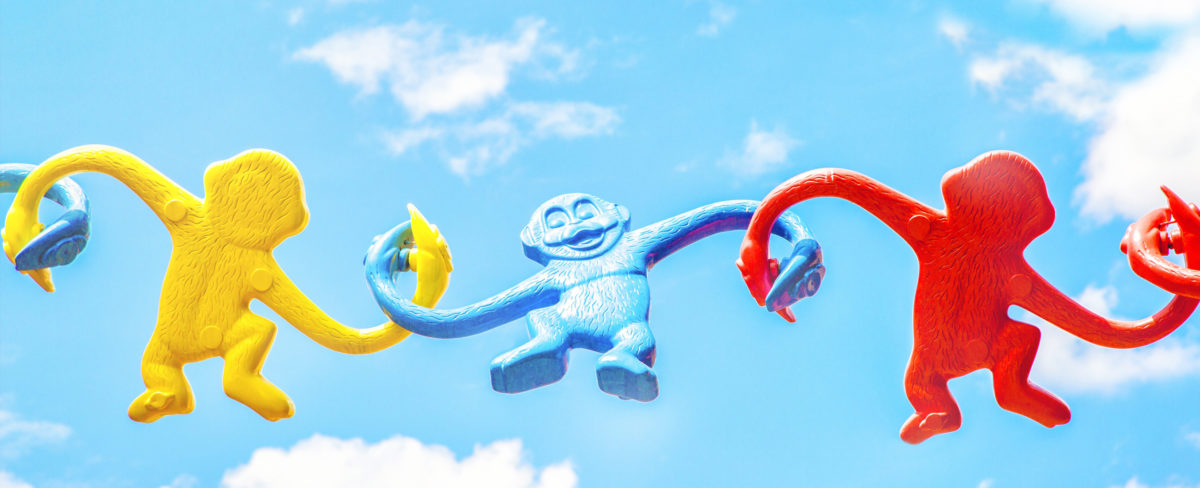 Plastic monkeys with linked hands